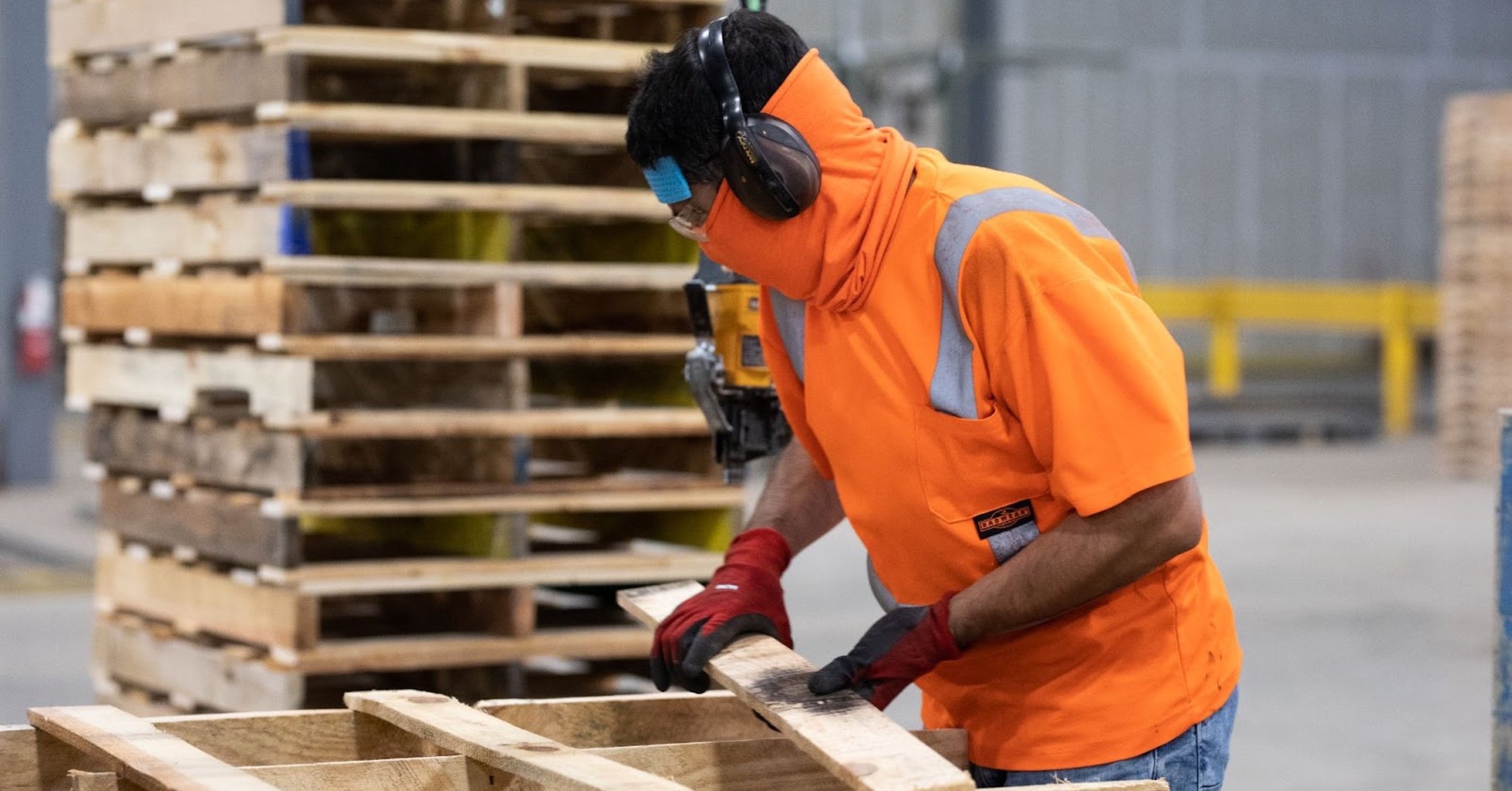 48forty Solutions employee working on recycled white wood pallets